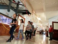 John B. Devalles elementary school students walk to class past the decorative lights hanging from the ceiling, as students across New Bedford return to school.  [ PETER PEREIRA/THE STANDARD-TIMES/SCMG ]